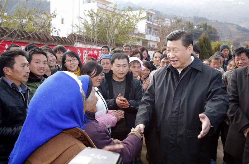 1月19日，習近平離開魯甸縣小寨鎮甘家寨紅旗社區過渡安置點時，同圍攏過來的群眾握手。新華社記者 鞠鵬 攝