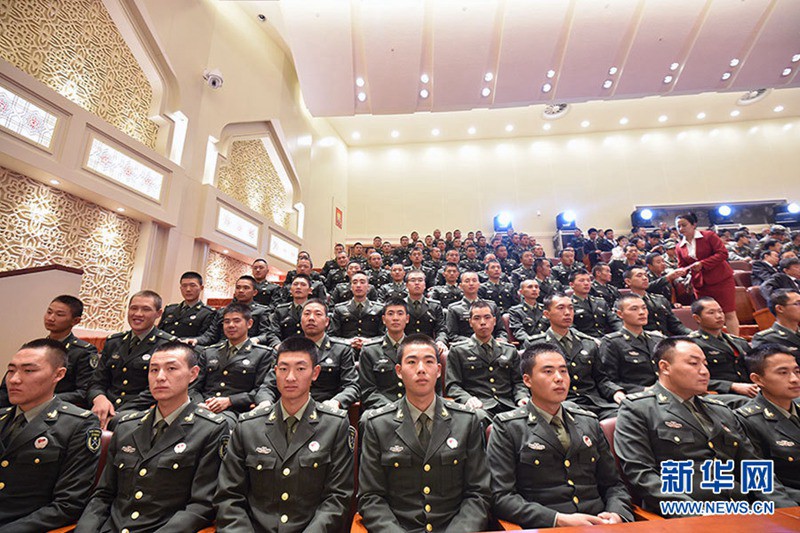 10月1日，庆祝中华人民共和国成立66周年暨新疆维吾尔自治区成立60周年大会在新疆人民会堂举行。图为参会的解放军代表入座。新华网记者 郭小天 摄