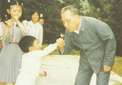 1987年4月，鄧小平在北京玉泉山和孫子一起吹蒲公英