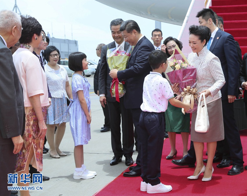 這是習近平和夫人彭麗媛在舷梯旁接受兩名香港少年敬獻鮮花。新華社記者 蘭紅光 攝