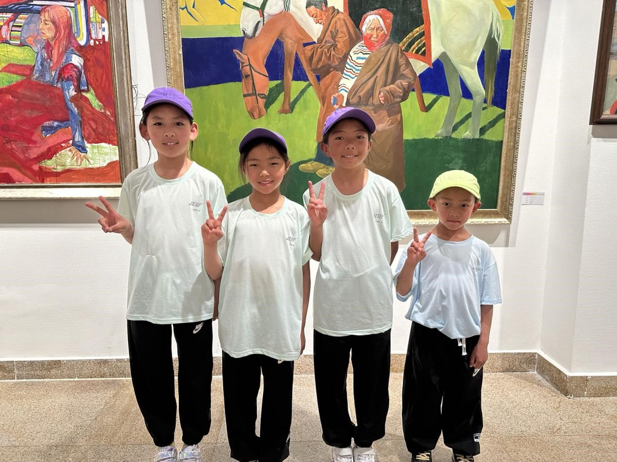 图为青海省玉树州儿童福利院的藏族青少年在中央民族大学美术展览馆内跟自己喜欢的油画合影留念。记者 益西康珠 摄
