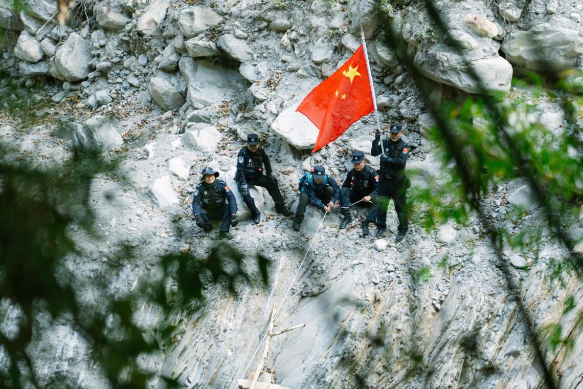 陡坡处,民警凭绳索行进。人民网 石曲次旺摄